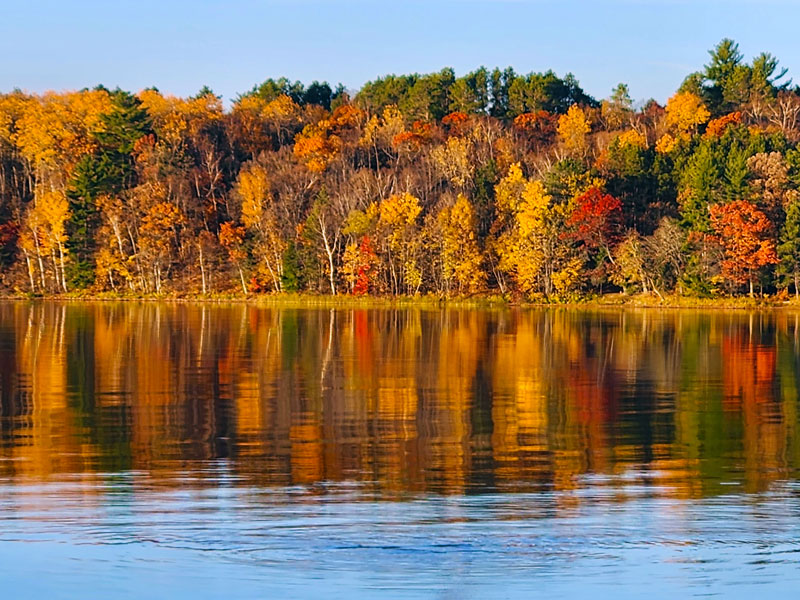 The fall colors reflecting in the lake at Minnesota's Eagle Nest Lodge.